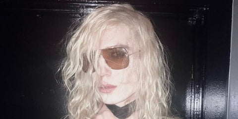 Celebrity rapper 2hollis was seen wearing gold Tom Ford Stavros TF1204 30E aviator sunglasses with yellow lenses in his Instagram post, December 2025.