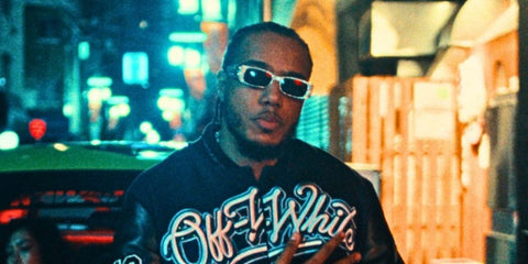 Rapper AJ Tracey was seen wearing crystal-studded Balenciaga BB0096S 013 rectangular sunglasses.