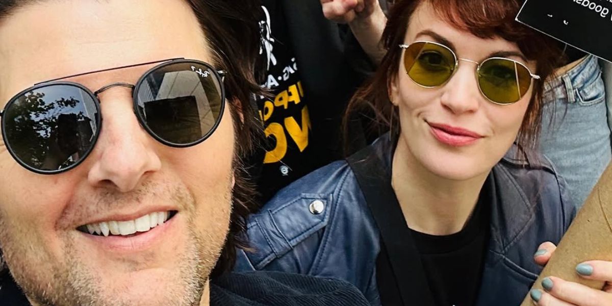 Adam Scott, pictured with fellow Severace actor Britt Lower, was seen wearing black Ray-Ban RB 3647N 002/58 Polarised round aviator sunglasses at the SAG-AFTRA strike