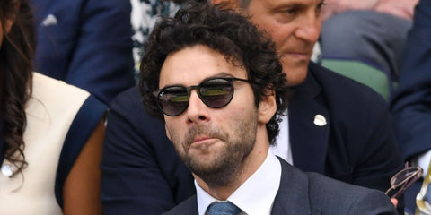 Irish actor Aidan Turner was seen wearing rubber black Ray-Ban Erika 4171 6228G round sunglasses with grey gradient lenses at the Wimbledon. Shop online now on Pretavoir.