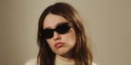Aimee Lou Wood was seen wearing black Versace 4501 GB1/87 sunglasses in the Versace Greca Eyewear campaign, October 2025.