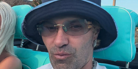 DJ and street artist Alec monopoly was seen wearing gold Miu Miu MU A51S 5AK50K sunglasses with light grey lenses in his Instagram post, June 2025