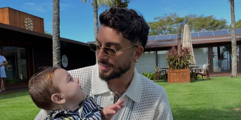 Brazilian footballer Alex Telles was seen wearing gold Prada PR A60S 5AK70G rectangular sunglasses with olive lenses in his Instagram post, September 2025.