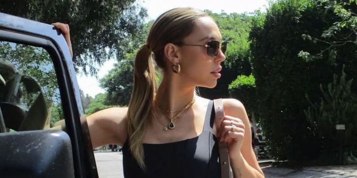 Alexis Ren was seen wearing gold Saint Laurent SL 312 M 014 sunglasses with brown lenses