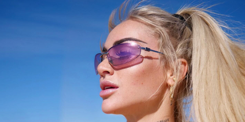 Swiss footballer Alisha Lehmann of Leicester City Women's F.C. was seen wearing silver Miu Miu MU A50S 1BC70Jsunglasses with pink lenses in her Instagram post, December 2024.