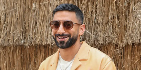 Anas Bukhash was seen wearing brown and bronze Zegna Orizzonte I EZ0231 48J sunglasses to attend the brand's Spring/Summer 2024 fashion show during Milan Men's Fashion Week