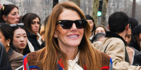 Anna dello Russo was seen wearing black Bottega Veneta BV1122S 001 sunglasses at the Miu Miu Fall/Winter 2025 during Paris Fashion Week