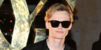 Anson Boon was seen wearing black Saint Laurent Sun SL 560 001 square sunglasses at the Saint Laurent Menswear Fall/Winter 2023 fashion show during Paris Men's Fashion Week