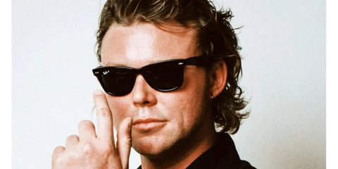 Australian musician Ashton Irwin was seen wearing the iconic black Ray-Ban Wayfarer 2140 901/58 Polarised sunglasses in the 5 Seconds of Summer band profile photo.