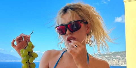 Ava Max was seen wearing black Prada Linea Rossa SPS 07Y DG010A sunglasses in Italy, shared through her Instagram post, in August 2023. Shop online now on Pretavoir