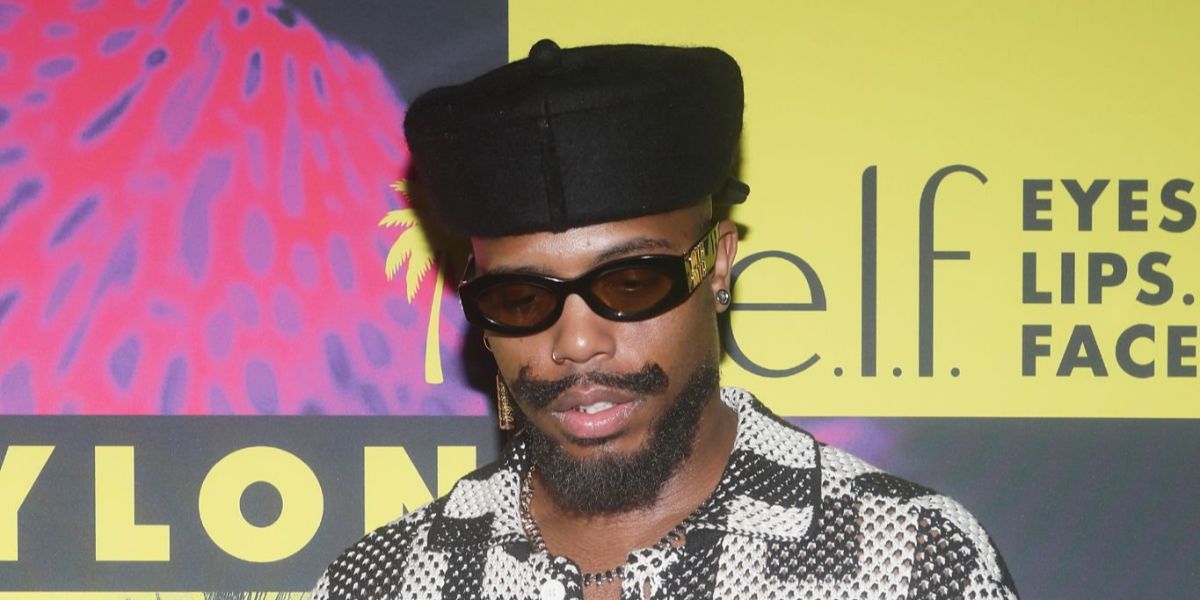 B.o.B was seen wearing black Miu Miu MU 11WS 16K10R sunglasses with yellow lenses  the NYLON House during Miami Art Week in December 2025.