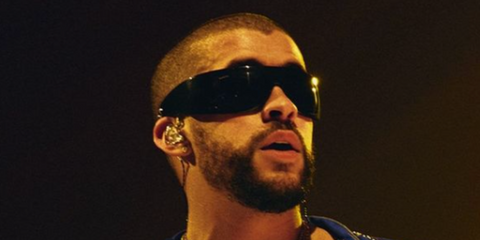 Bad Bunny wears black Gucci wraparound sunglasses while performing on stage - buy online