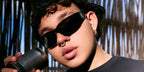 Colombian singer Beele was seen wearing black Prada PR A14S 1AB5S0 wraparound sunglasses in a Billboard feature.