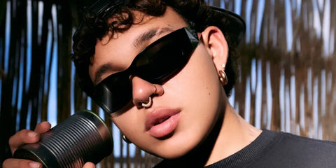 Colombian singer Beele was seen wearing black Prada PR A14S 1AB5S0 wraparound sunglasses in a Billboard feature.