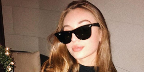 Actress Bella Podaras was seen wearing black Ray-Ban Wayfarer RB 4340 601 sunglasses in a social media post.