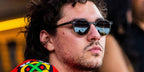 Off Campus star Belmont Cameli wore black Oliver Peoples Riley Sun OV5004SU 1005/P1 round sunglasses with green g-15 Polarised lenses during the ice hockey hame between Chicago Blackhawks against the St. Louis Blues in October 2026