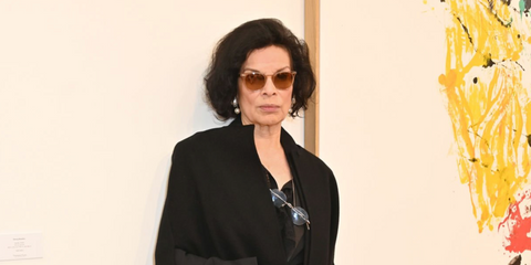 Bianca Jagger was seen wearing Oliver Peoples Finley Esq Sun OV5298SU 1471/42 Blush/Rose Quartz sunglasses at the Frieze Art Fair 2024 VIP preview in London