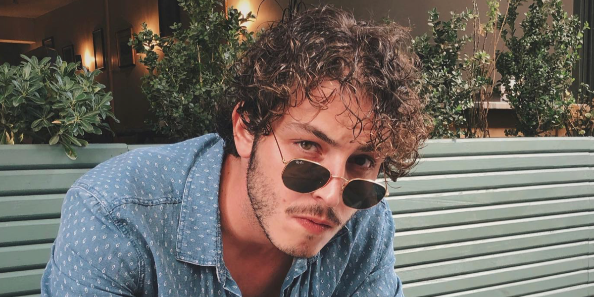 Turkish actor Boran Kuzum was seen wearing Ray-Ban RB 3548N 001 Hexagonal Gold With Flat Lenses sunglasses in his Instagram post, July 2020.