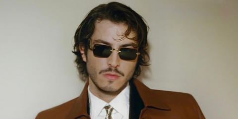 Turkish actor Boran Kuzum was seen wearing gold Ray-Ban x ASAP Rocky Metal RB 3928 001/71 rimless rectangular sunglasses at the New York premiere of Netflix's Big Mistakes