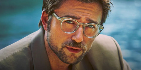 Brandon Sklenar was seen wearing transparent Oliver Peoples Sheldrake OV5036 1762 optical glasses in the Oliver Peoples Spring 2025 campaign