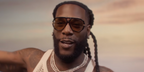 Burna Boy was seen wearing black Bottega Veneta BV1274S 002 aviator sunglasses with yellow lenses in the World Cup 2026 official music video Dai Dai with Shakira.