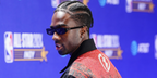 Caleb McLaughlin was seen wearing black Saint Laurent Sun SL 557 Shade 001 slim sunglasses during the NBA All-Star Game-VIP Blue Carpet Arrivals