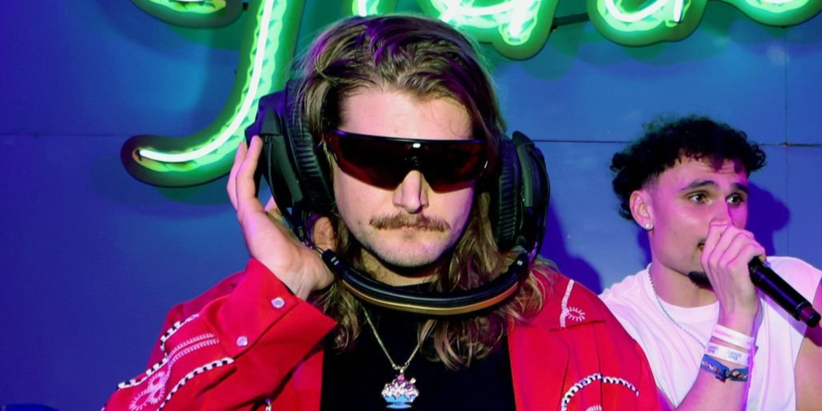 Blogger and podcaster Caleb Pressley was seen wearing black Oakley Meta Vanguard OW8001 01 Prizm Smart Glasses with red lenses at the Stagecoach Music Festival 2026
