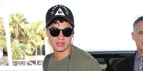 Australian musician Calum Hood of 5 Seconds of Summer was seen wearing black Ray-Ban Erika RB 4171 601/2P Polarised round sunglasses at LAX, August 2016.