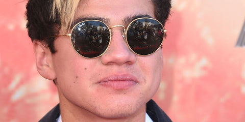 Australian musician Calum Hood of 5 Seconds of Summer was seen wearing gold xRay-Ban Round Metal 3447 001  sunglasses at the iHeart Radio Music Awards 2015.