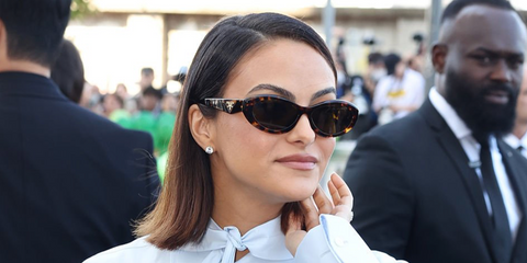 Camila Mendes was seen wearing tortoise Prada PR 26ZS 14L09Z cat eye sunglasses at the Prada Spring/Summer 2027 show during Milan Fashion Week.