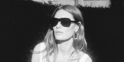 Camille Rowe was seen wearing black Saint Laurent Sun SL 609 Carolyn 001 sunglasses in her Instagram post