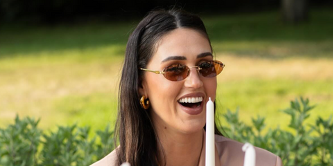 Argentine internet personality Cecilia Rodriguez was seen wearing Miu Miu MU A54S 1BC90Q oval sunglasses with brown lenses in her Instagram post, June 2025.