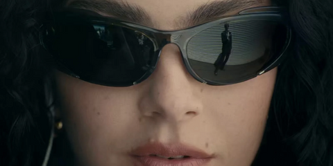 Charli XCX wearing Balenciaga black wraparound sunglasses in her new music video for Guess, featuring Billie Eilish.