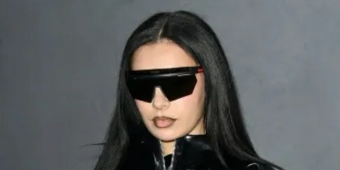 Charli XCX wearing Prada Linea Rossa wraparound sunglasses - buy online.