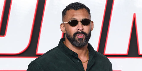 Mixed martial artist and actor Chi Lewis-Parry was seen wearing gold Ray-Ban RB 3774D 001/73 oval sunglasses with brown lenses at the UK premiere of The Running Man, November 2025. Shop online now on Pretavoir
