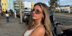 Television personality Chloe Burrows of Love Island (2021) was seen wearing Miu Miu MU A51S 5AK50K rimless sunglasses with light grey lenses in her Instagram post, February 2026.