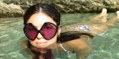 Content creator Clara Kong Vila was seen wearing black Prada PR B21S 16K30G sunglasses with purple lenses in her Instagram post, August 2025.