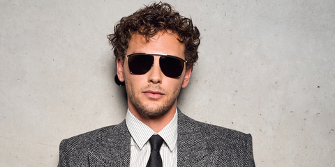 Actor Cooper Koch was seen wearing silver Saint Laurent Victoire SL 820 001 sunglasses at the Saint Laurent Menswear Spring/Summer 2026 fashion show during Paris Men's Fashion Week.