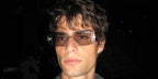 Italian model and internet personality Corrado Martini was seen wearing transparent Prada PR 17WS 19X30N sunglasses at the Sound of Prada event in Berlin, June 2025.