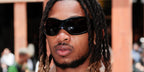 DDG was seen wearing black Balenciaga BB0251S 001 Skin Cat sunglasses at Sacai Menswear Spring/Summer 2025 fashion show during Paris Men's Fashion Week
