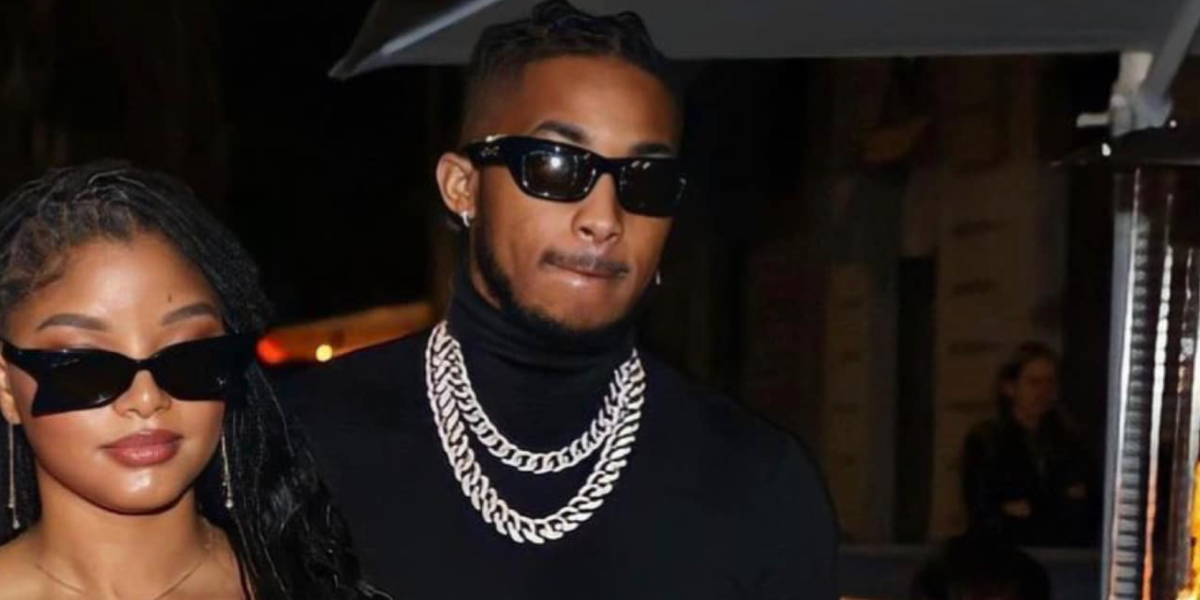 DDG, pictured with Halle Bailey, was seen wearing black Gucci GG1296S 001 square cat eye sunglasses to attend Gucci Fall/Winter 2023 fashion show and after party during Milan Fashion Week