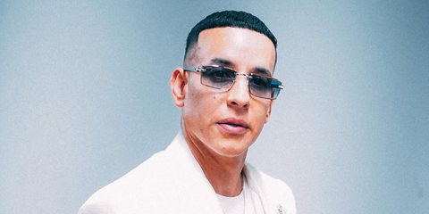 Daddy Yankee was seen wearing silver Cartier CT0582S 004 rimless rectangular sunglasses with blue gradient lenses in January 2026.