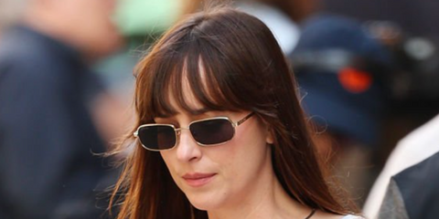 Actress Dakota Johnson on the set of 'Materialists' on May 8th 2024 in New York wearing gold Gucci rectangle sunglasses