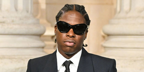 Canadian singer Daniel Caesar was seen wearing black Prada PR A27S 16K5S0 sunglasses at the Saint Laurent Menswear Fall/Winter 2025 fashion show during Paris Men's Fashion Week