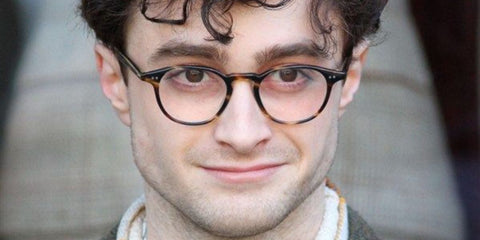 Daniel Radcliffe is seen wearing tortoiseshell Oliver Peoples Emerson OV5062 1003 optical glasses while filming Kill Your Darlings