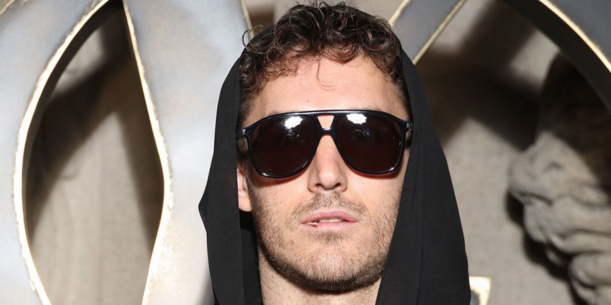 David Alexander Flinn was seen wearing black Saint Laurent Sun SL 596 Dune 001  aviator sunglasses at the Saint Laurent Fall/Winter 2023 fashion show during Paris Fashion Week.