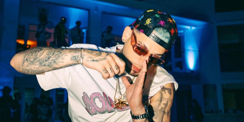Puerto Rican rapper Dei V was seen wearing transparent peach Prada PR 17WS 19Q10D sunglasses in his Instagram post, November 2025,