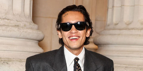 Actor and singer Dominic Fike was seen wearing the iconic Ray-Ban Wayfarer 2140 901 Black sunglasses at the Saint Laurent Menswear Fall/Winter 2025 fashion show during Paris Men's Fashion Week