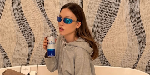 Turkish influencer and YouTuber Duygu Ozaslan was seen wearing silver Miu Miu MU A50S 1BC10K sunglasses with green blue mirror lenses in Dubai, shared through her Instagram post in November 2025.