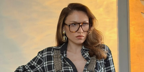Turkish influencer and YouTuber Duygu Ozaslan was seen wearing brown yellow tortoiseshell Saint Laurent SL 596 Dune Opt 002 aviator optical glasses in her Instagram post, November 2025.